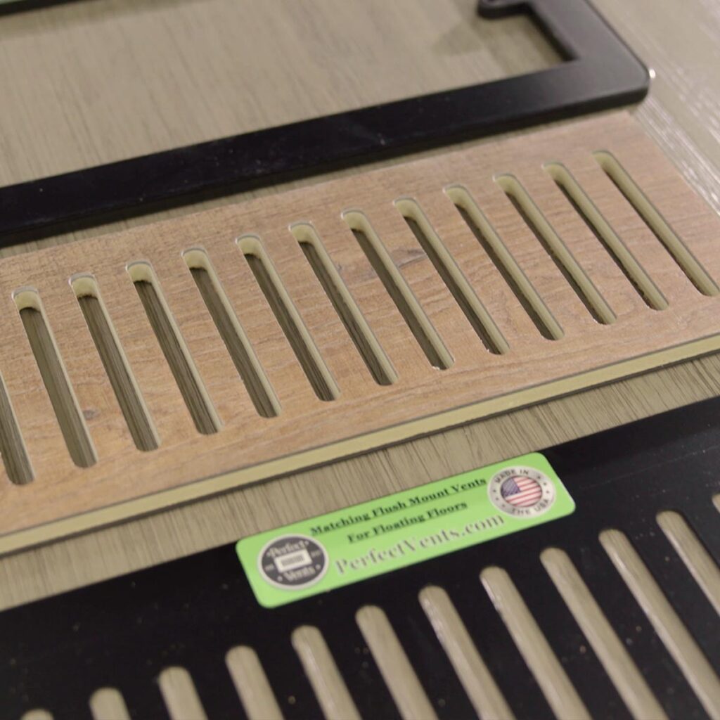 Close-up view of custom floor vent covers Aurora CO crafted from matching wood laminate material.