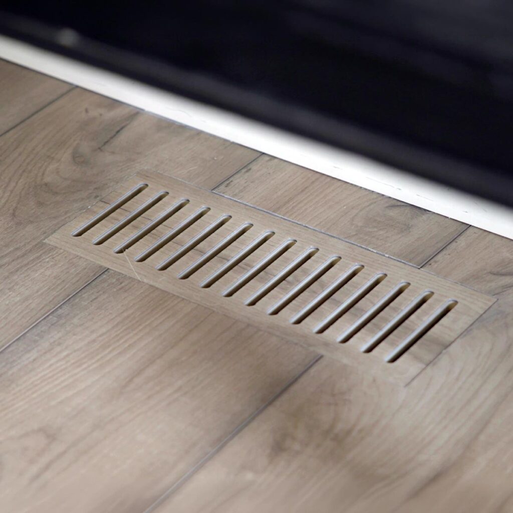Close-up view of custom floor vent covers Naperville IL crafted from matching wood laminate material.