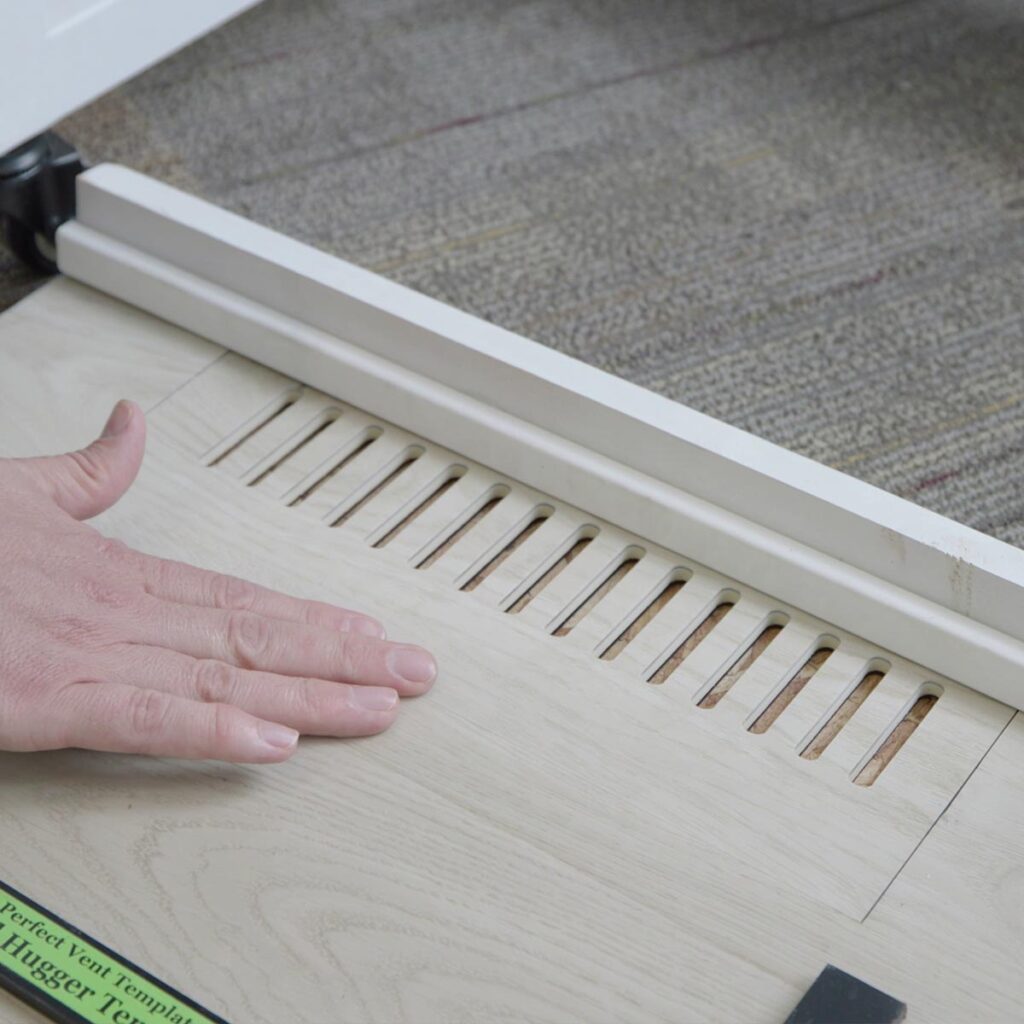 Close-up view of custom floor vent covers Omaha NE crafted from matching wood laminate material.