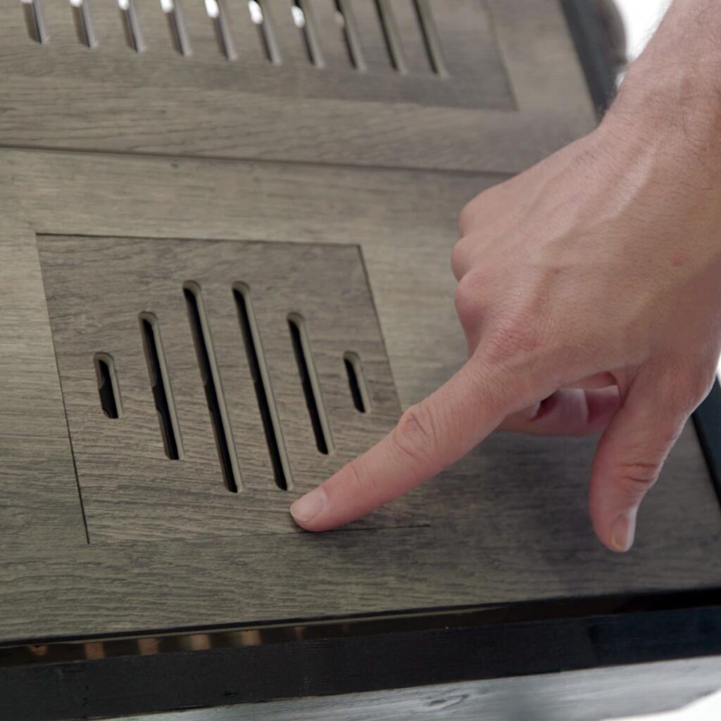 Close-up view of custom floor vent covers Westminster CO crafted from matching wood laminate material.