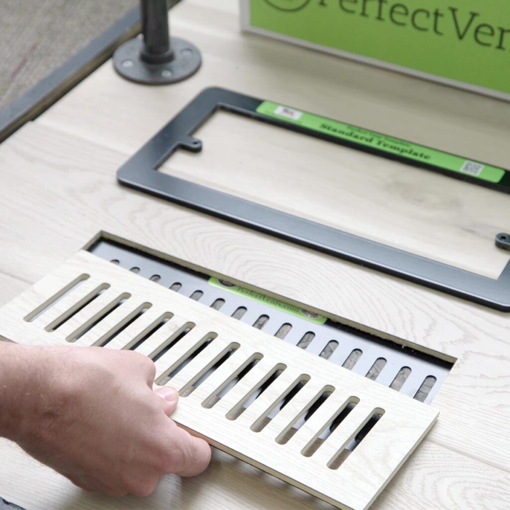 Close-up view of custom floor vent covers service areas crafted from matching wood laminate material.